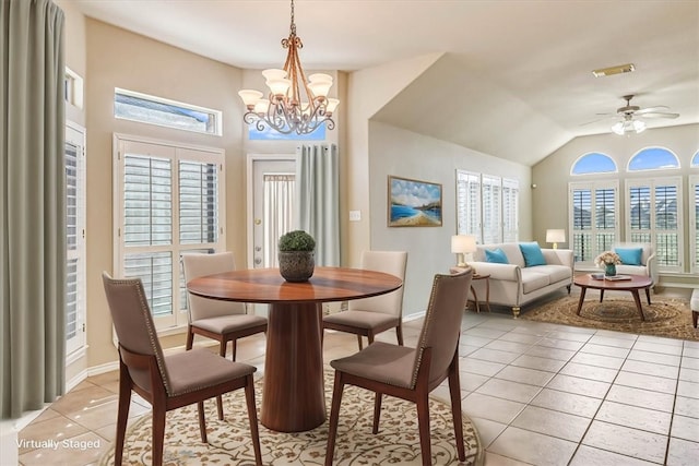 dining room with light tile patterned floors, visible vents, vaulted ceiling, baseboards, and ceiling fan with notable chandelier