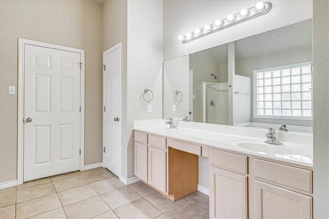 full bath featuring a sink, double vanity, tile patterned flooring, and a shower stall