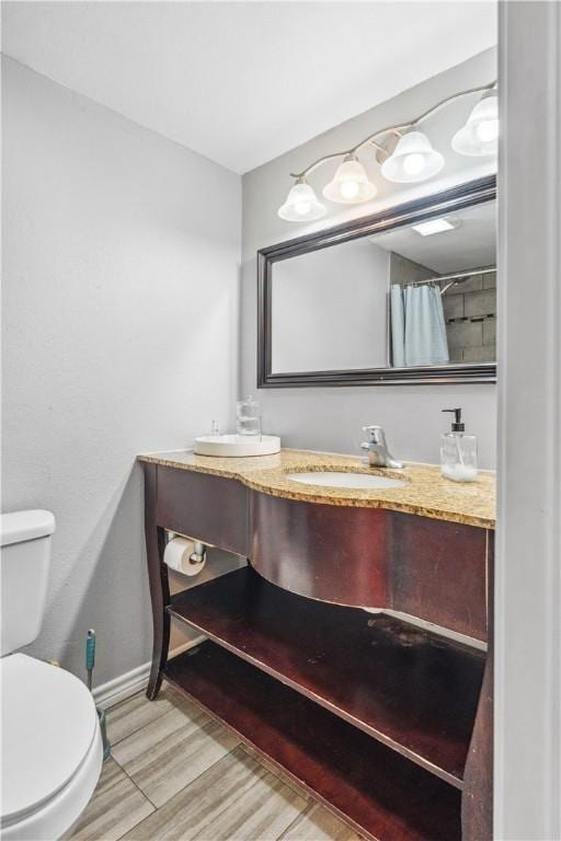 4430 Mistletoe Dr, Corpus Christi, TX 78411 - bathroom featuring double vanity, wood finished floors, and a shower with shower curtain