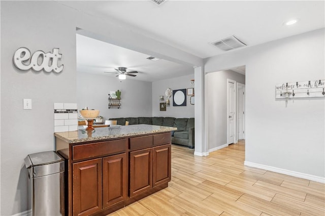 4430 Mistletoe Dr, Corpus Christi, TX 78411 - kitchen with light wood-style floors, ceiling fan, light stone countertops, open floor plan, and recessed lighting