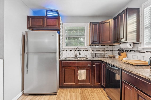 4430 Mistletoe Dr, Corpus Christi, TX 78411 - kitchen with freestanding refrigerator, dishwasher, decorative backsplash, and light wood-type flooring