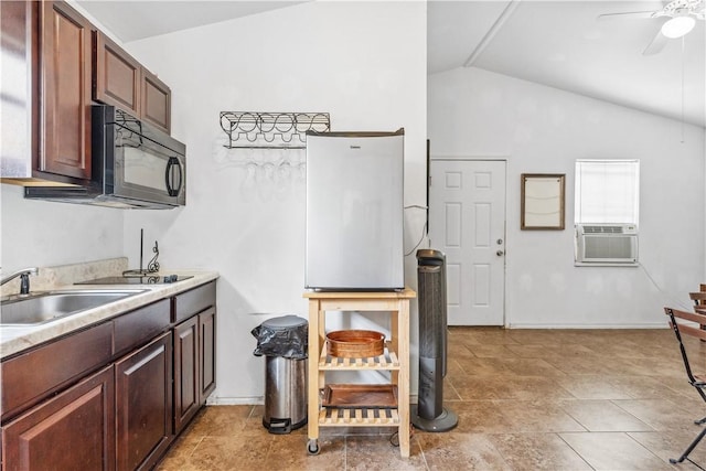 4430 Mistletoe Dr, Corpus Christi, TX 78411 - kitchen with black microwave, cooling unit, lofted ceiling, ceiling fan, and light countertops