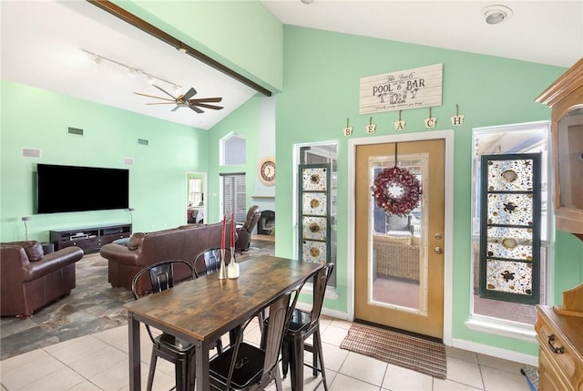 dining room with ceiling fan, light tile patterned flooring, and lofted ceiling