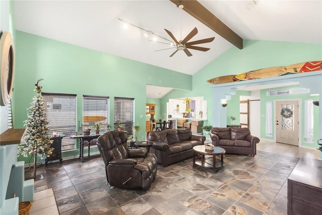 living room with a barn door, ceiling fan, beamed ceiling, and high vaulted ceiling