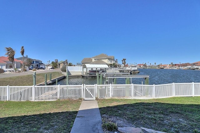 dock area featuring a yard and a water view