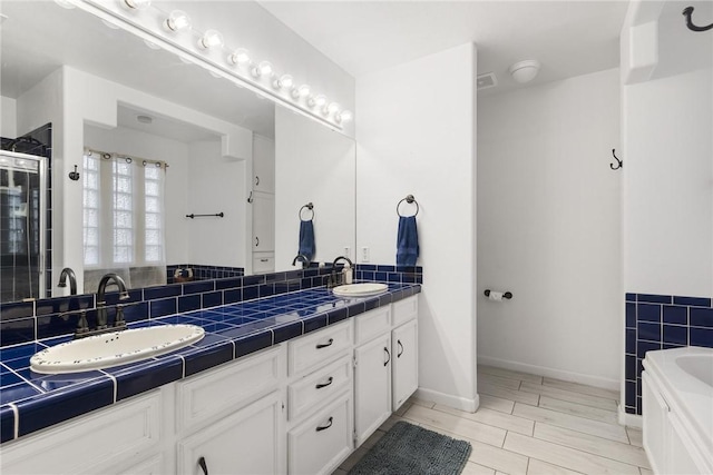 bathroom featuring separate shower and tub and vanity