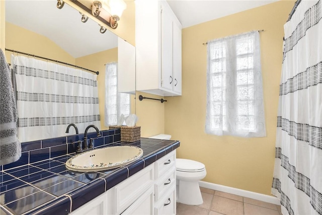 bathroom featuring tile patterned floors, vanity, and toilet