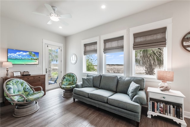 living room featuring ceiling fan, wood-type flooring, and plenty of natural light