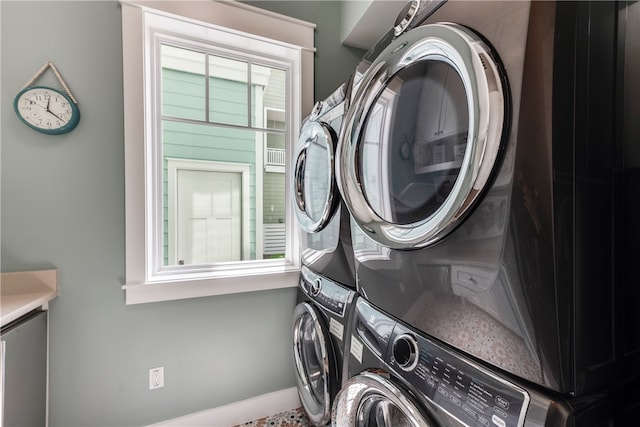 clothes washing area with stacked washer and dryer