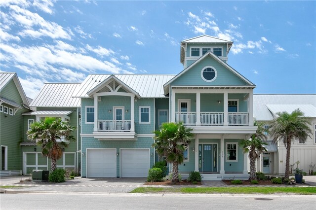 view of front of house featuring a garage and a balcony