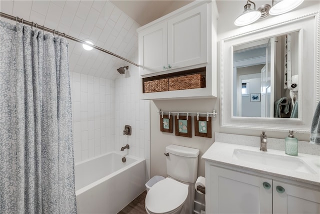 full bathroom with shower / tub combo with curtain, vanity, and toilet