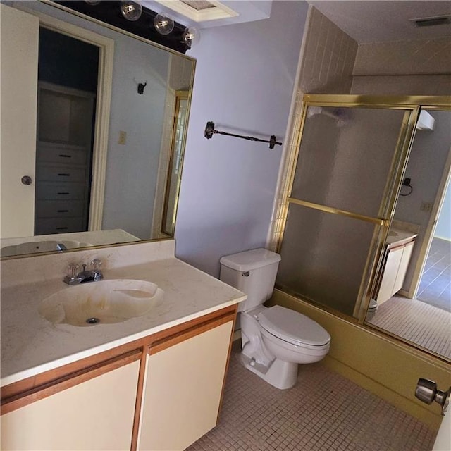 full bathroom featuring tile patterned flooring, enclosed tub / shower combo, vanity, and toilet