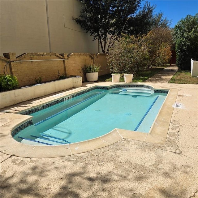 view of pool featuring a swimming pool and fence