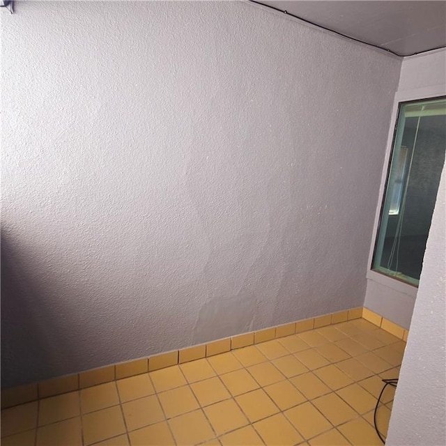 unfurnished room with a textured wall