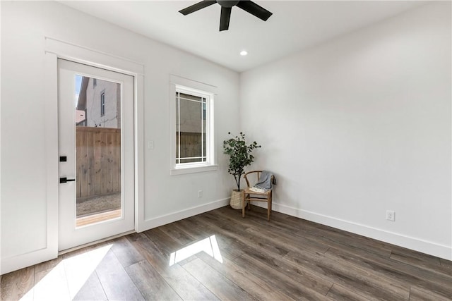 empty room featuring ceiling fan and dark hardwood / wood-style flooring