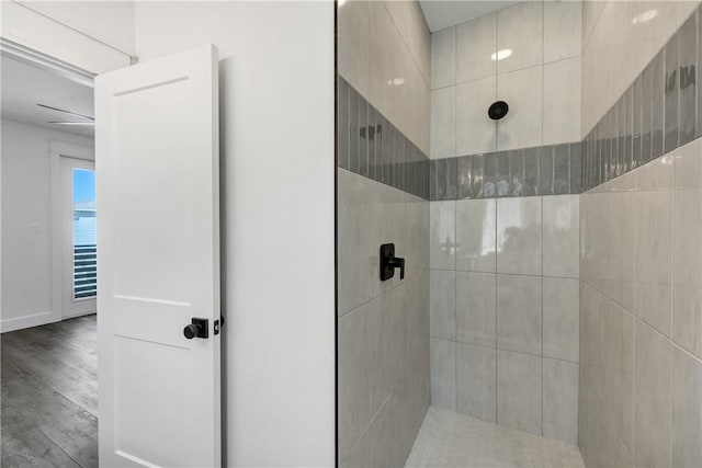 bathroom featuring hardwood / wood-style floors and a tile shower