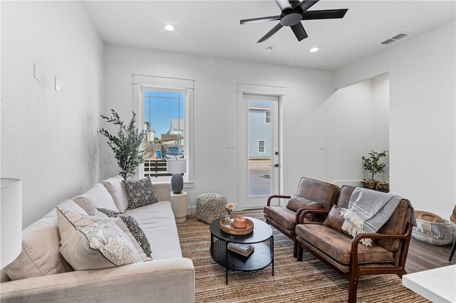 living room with hardwood / wood-style flooring and ceiling fan