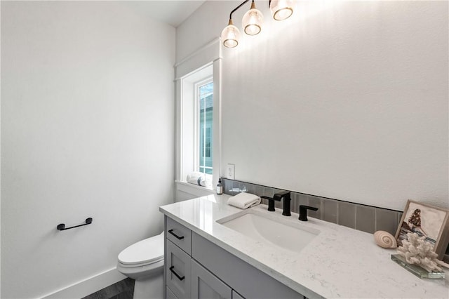 bathroom featuring vanity and toilet