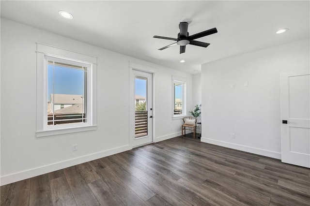 unfurnished room featuring ceiling fan and dark hardwood / wood-style flooring