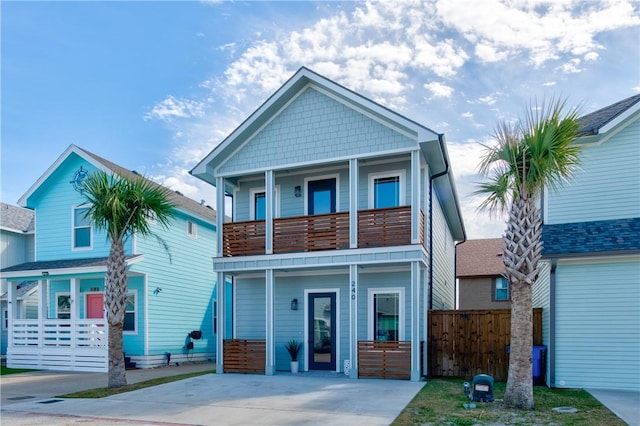 view of front of property featuring a porch, fence, and a balcony