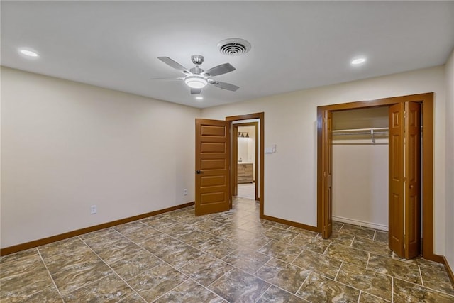 unfurnished bedroom with ceiling fan and a closet