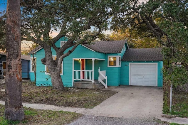 view of front of house with covered porch and a garage