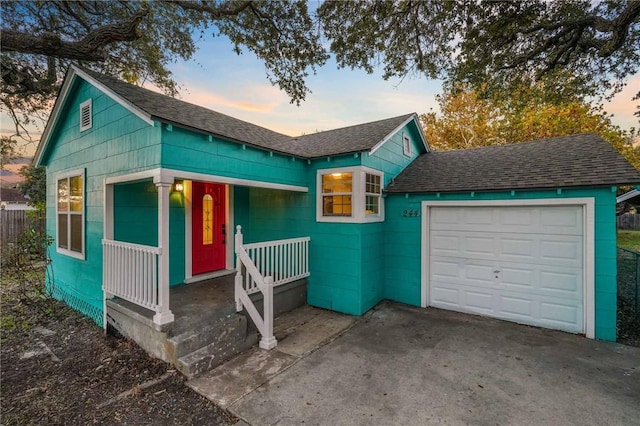 view of front of house with covered porch and a garage