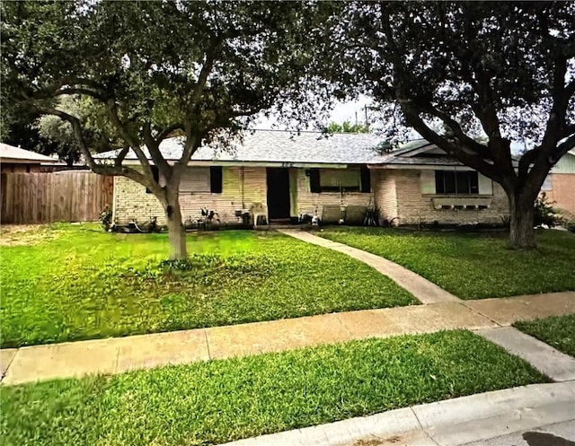 ranch-style home with a front lawn