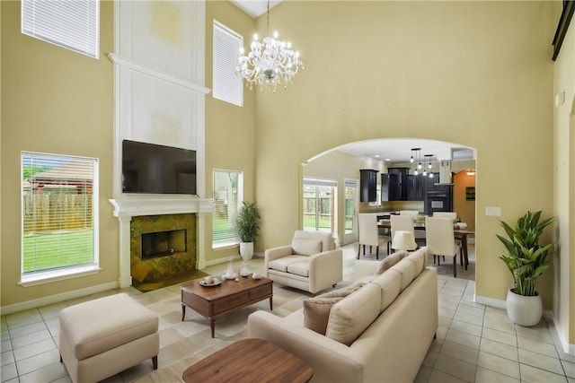 7445 Lake Micala Dr, Corpus Christi, TX 78413 - living area featuring a towering ceiling, arched walkways, a chandelier, light tile patterned floors, and a fireplace