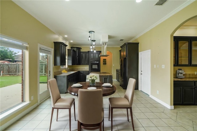 7445 Lake Micala Dr, Corpus Christi, TX 78413 - dining room with arched walkways, crown molding, light tile patterned floors, and recessed lighting