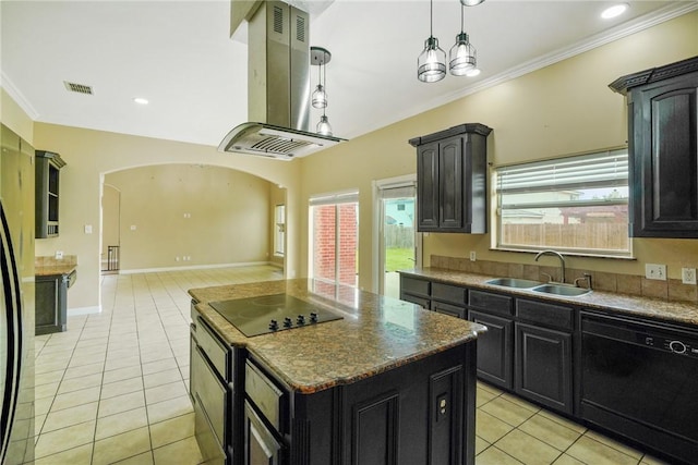 7445 Lake Micala Dr, Corpus Christi, TX 78413 - kitchen with black appliances, island range hood, light tile patterned floors, arched walkways, and dark cabinetry