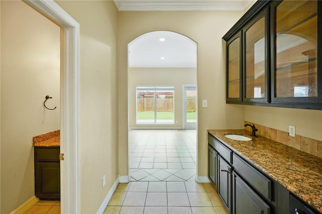 7445 Lake Micala Dr, Corpus Christi, TX 78413 - corridor featuring light tile patterned floors, arched walkways, and crown molding