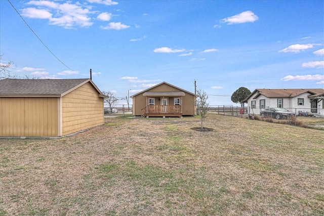 view of yard with an outbuilding, fence, and a wooden deck