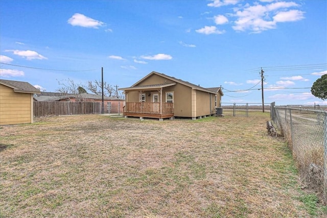 view of yard featuring a deck, a fenced backyard, and central air condition unit