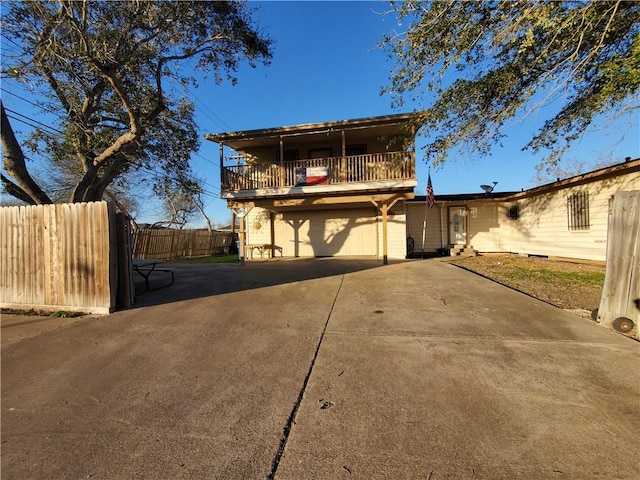 view of front property with a garage and a balcony