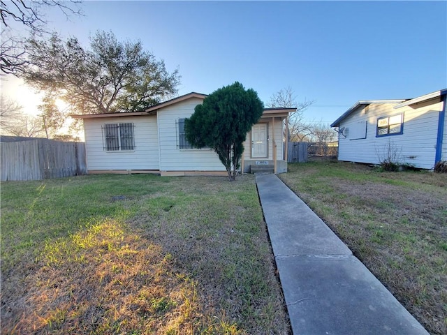 view of front of property with a front lawn and fence