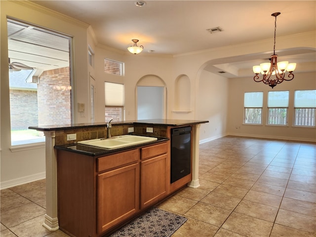 kitchen with pendant lighting, sink, crown molding, black dishwasher, and a center island with sink