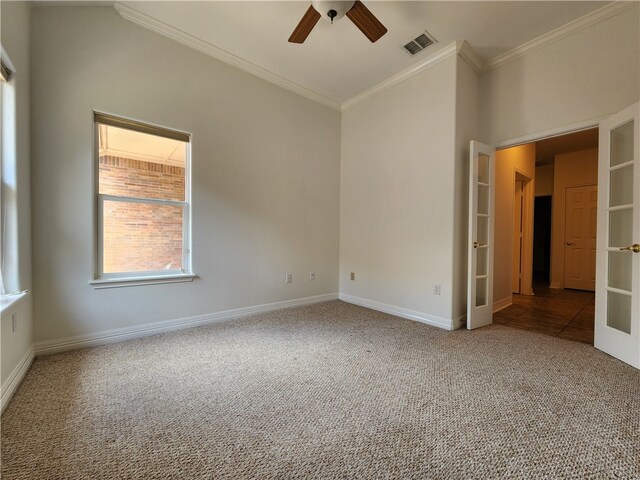 carpeted empty room featuring crown molding, french doors, and ceiling fan