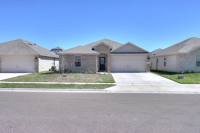 7510 Lasso Dr, Corpus Christi, TX 78414 - ranch-style house with brick siding, concrete driveway, an attached garage, central AC unit, and a front lawn