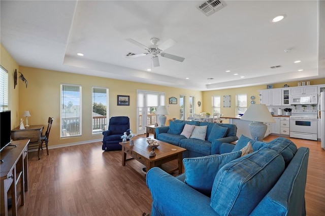 living room with plenty of natural light, ceiling fan, wood finished floors, and recessed lighting