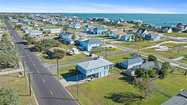 aerial view of residential area featuring a large body of water
