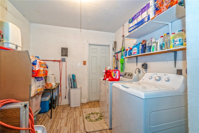 laundry room with washer and clothes dryer and light wood-type flooring