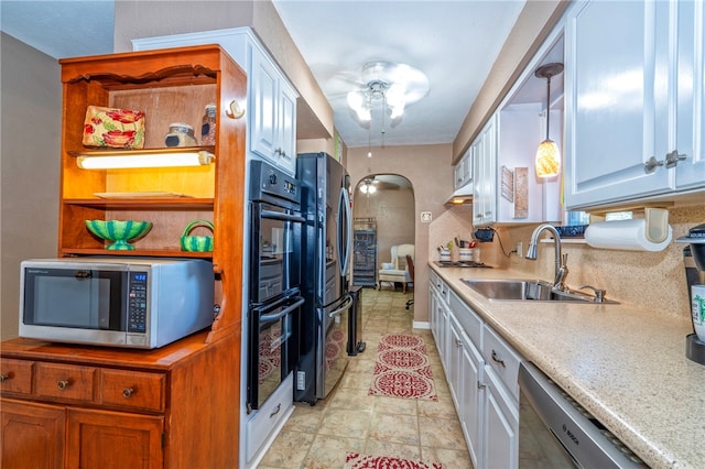 kitchen featuring pendant lighting, white cabinetry, sink, and black appliances