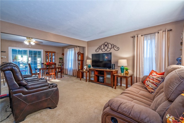 carpeted living room with ceiling fan