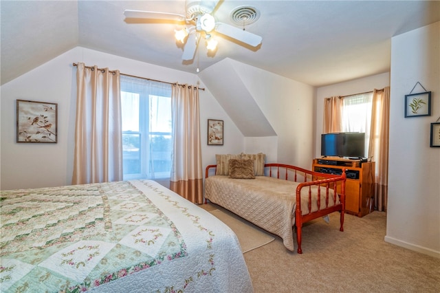 carpeted bedroom featuring multiple windows, ceiling fan, and lofted ceiling