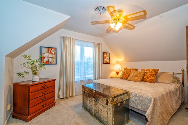 bedroom featuring ceiling fan, light carpet, and vaulted ceiling