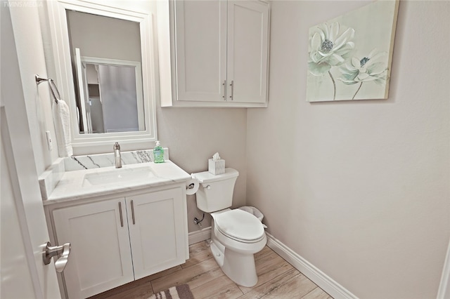 6701 Paddington Dr, Corpus Christi, TX 78414 - bathroom featuring toilet, wood finished floors, vanity, and baseboards