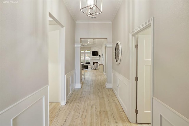 6701 Paddington Dr, Corpus Christi, TX 78414 - corridor featuring a decorative wall, light wood finished floors, wainscoting, and ornamental molding