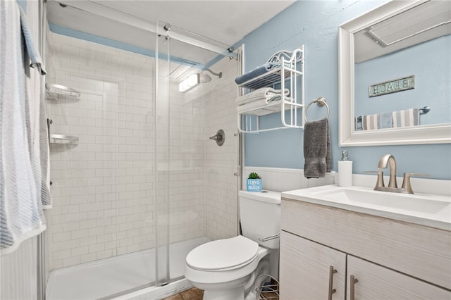 bathroom featuring vanity, walk in shower, and toilet