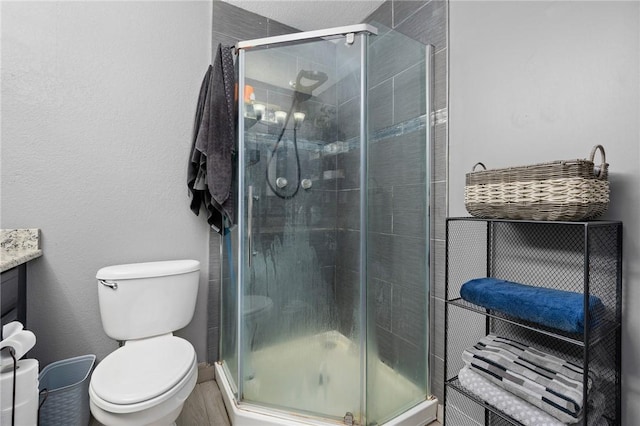 full bathroom with a stall shower and toilet